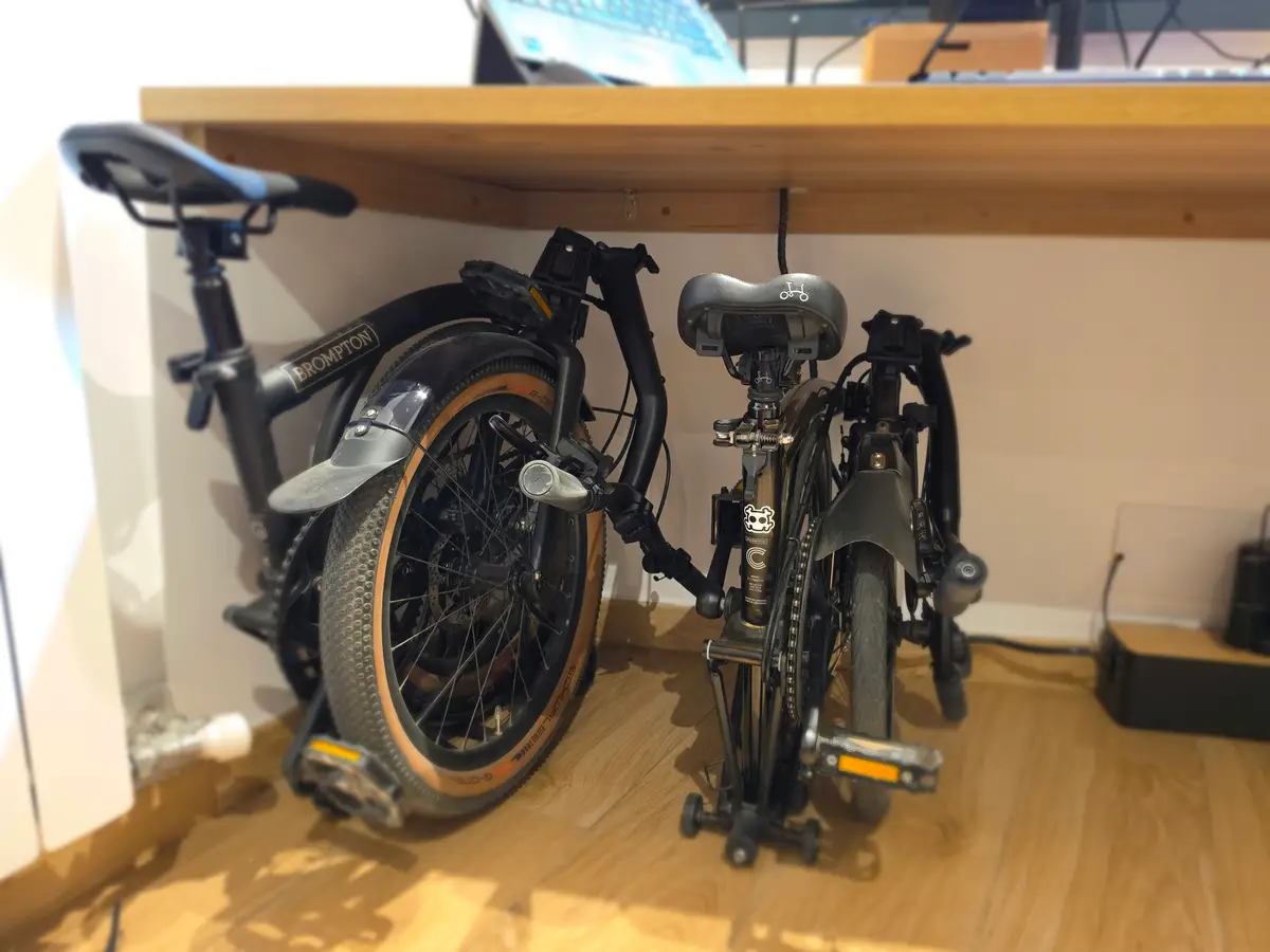 A folded Brompton G-Line and C-Line side by side; the G-Line is taller and bulkier on bigger 20-inch wheels.